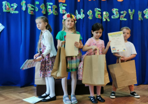 Czteroosobowy zespół z dyplomami i upominkami