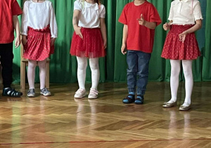 Grupa dzieci stoi i śpiewa piosenkę