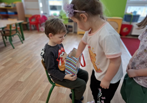 Chłopiec częstuje dzieci cukierkami