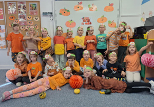 Dzieci pozują do zdjęcia z wykonanymi przez siebie opaskami