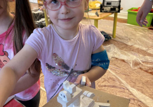 Dziewczynka prezentuje swoją pracę