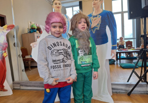 Chłopcy pozują do zdjęcia w teatralnych perukach