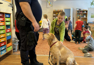 Strażnik miejski i chłopiec głaszczący psa
