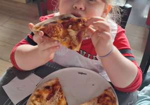 Dziewczynka je pizzę przez siebie zrobioną