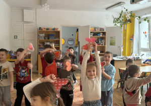 Dzieci tańczą z sercami w dłoni