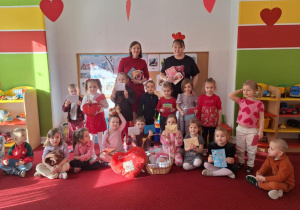 Dzieci i panie pozują do zdjęcia z walentynkami, które otrzymały