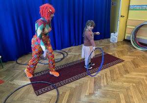 Pani w kolorowym stroju i dziewczynka z hula-hop