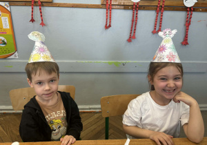 Chłopiec i dziewczynka w wiosennych czapeczkach