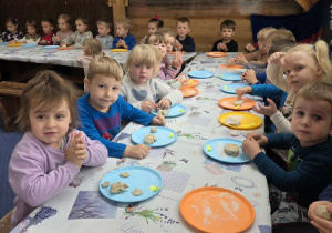 Dzieci wyrabiają ciasto na bułeczki