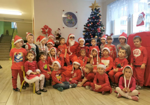 Grupa dzieci pozuje do zdjęcia z Mikołajem